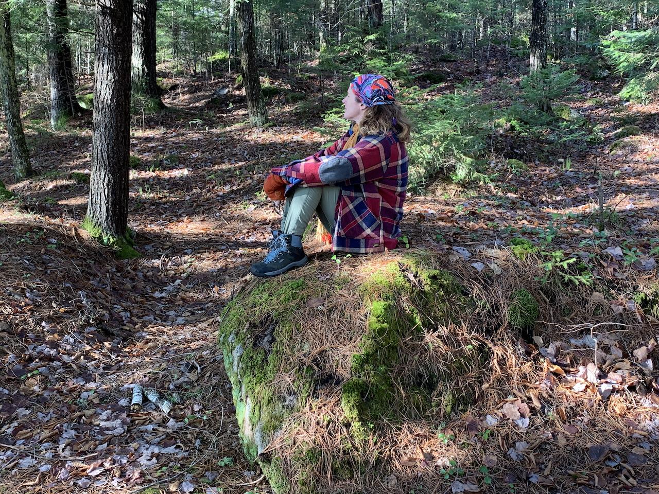 Rae Carter sitting on a mossy rock